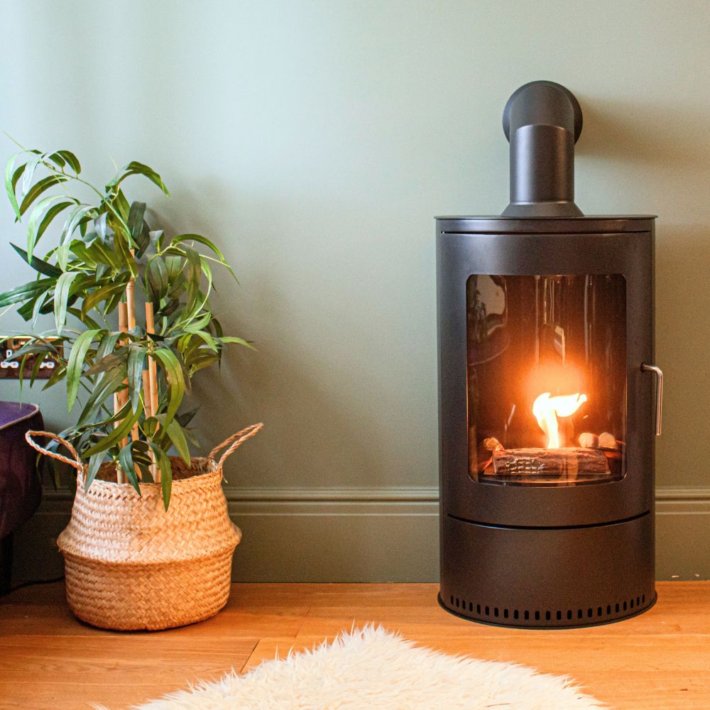 A stylish lamp featuring a copper pipe and bulb, elegantly placed on a wooden table.