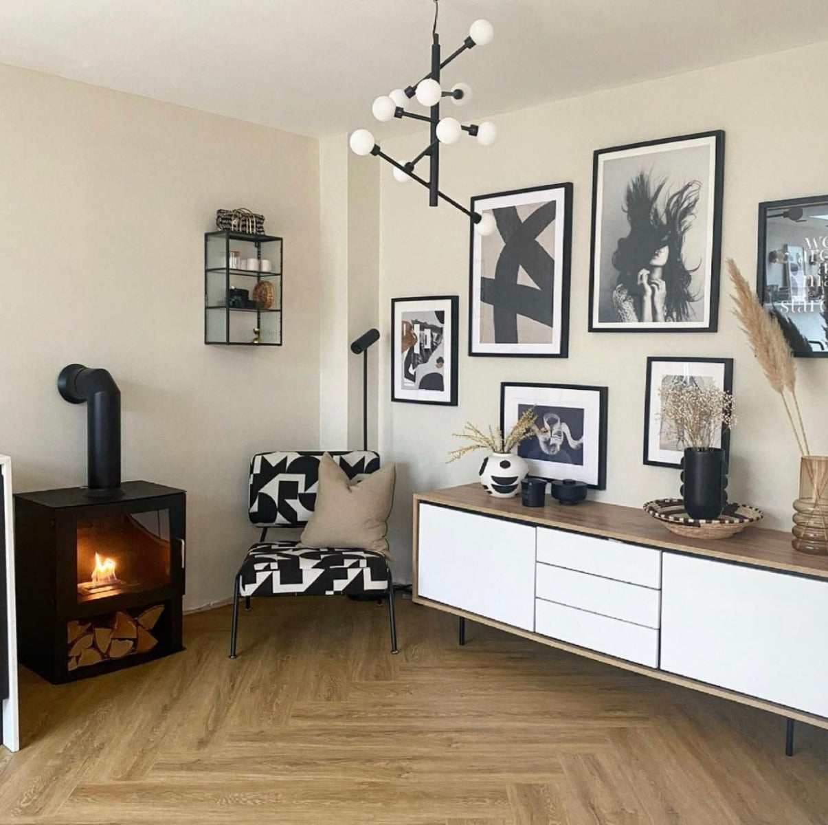 Rectangular bioethanol fireplace with false flue sitting on the floor next to black and white chair