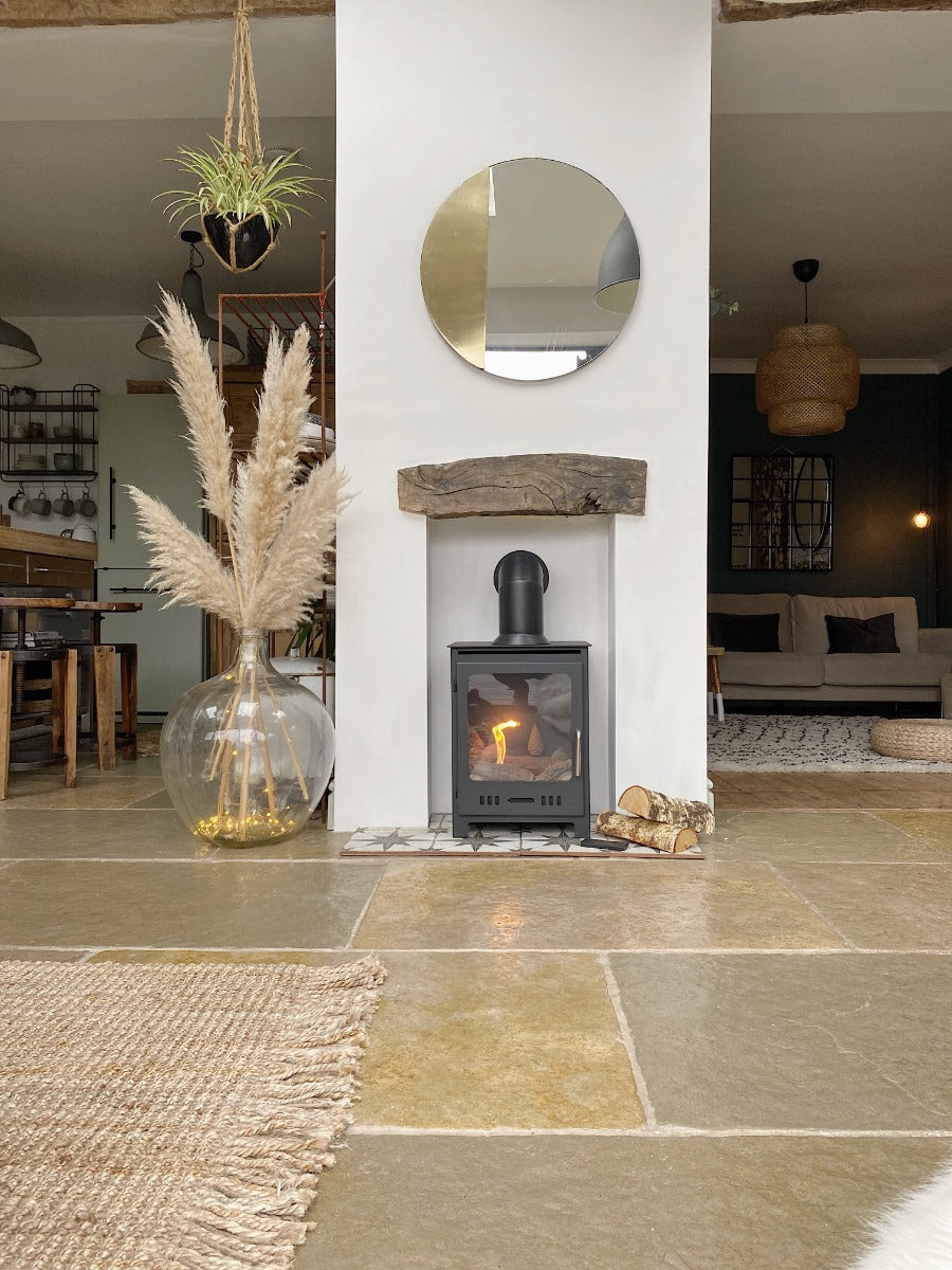 Rectangular bioethanol fireplace with a false flue in a traditional insert under a circular mirror