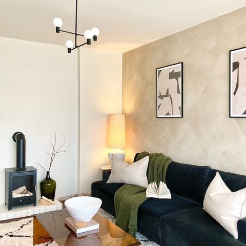 Black bioethanol fireplace next to a large black sofa