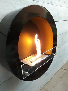 Round black bioethanol fireplace mounted on the wall