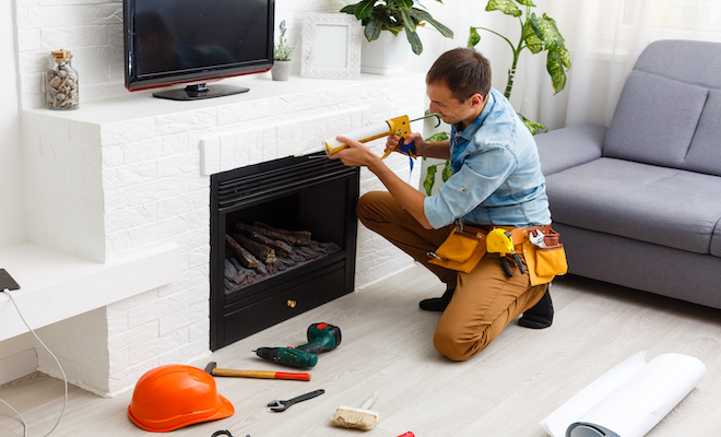 Worker opening up a white fireplace