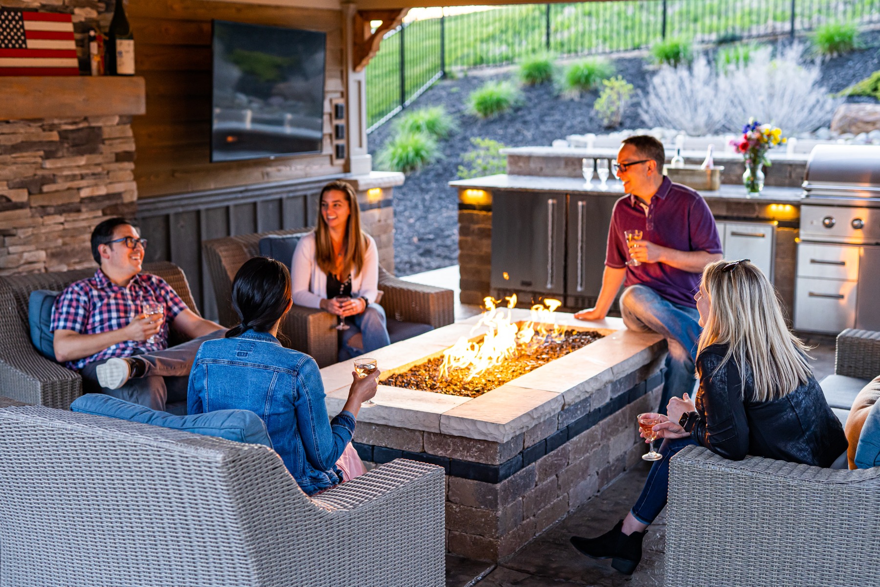 Group of friends in patio with heater in the middle