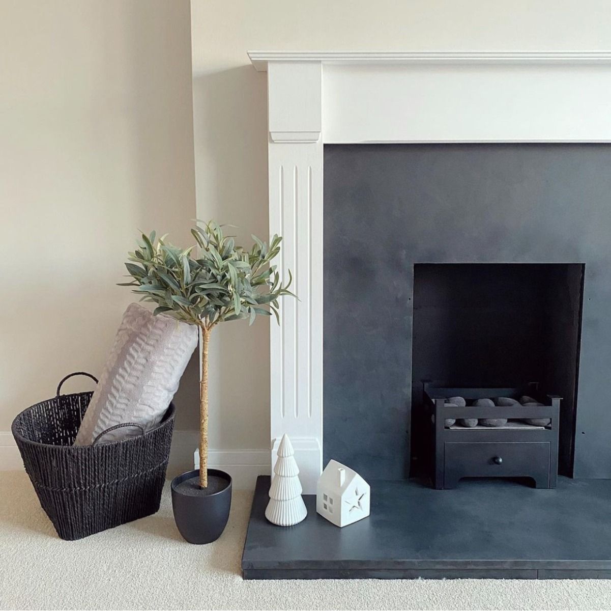 Small black bioethanol fireplace in a traditional black and white insert