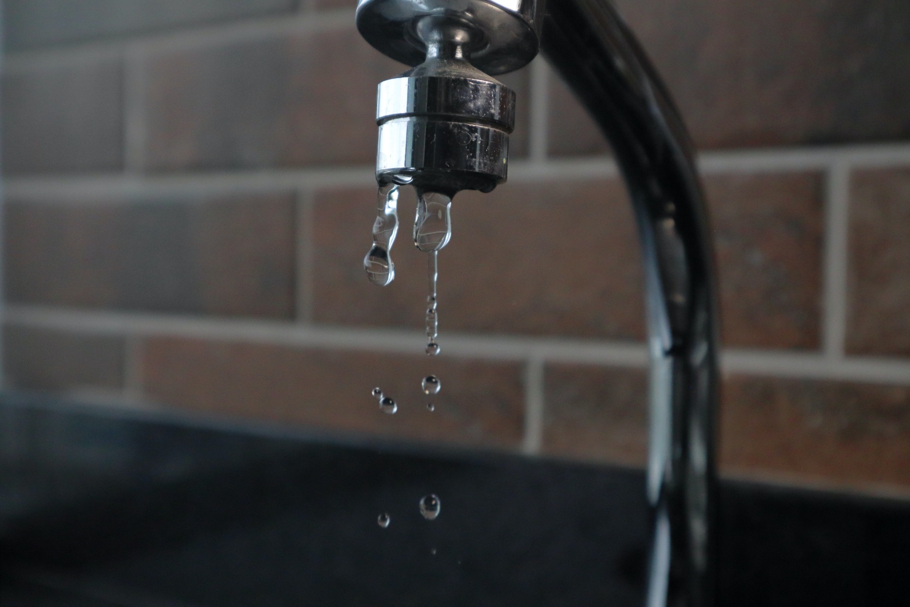 Metallic tap dripping water