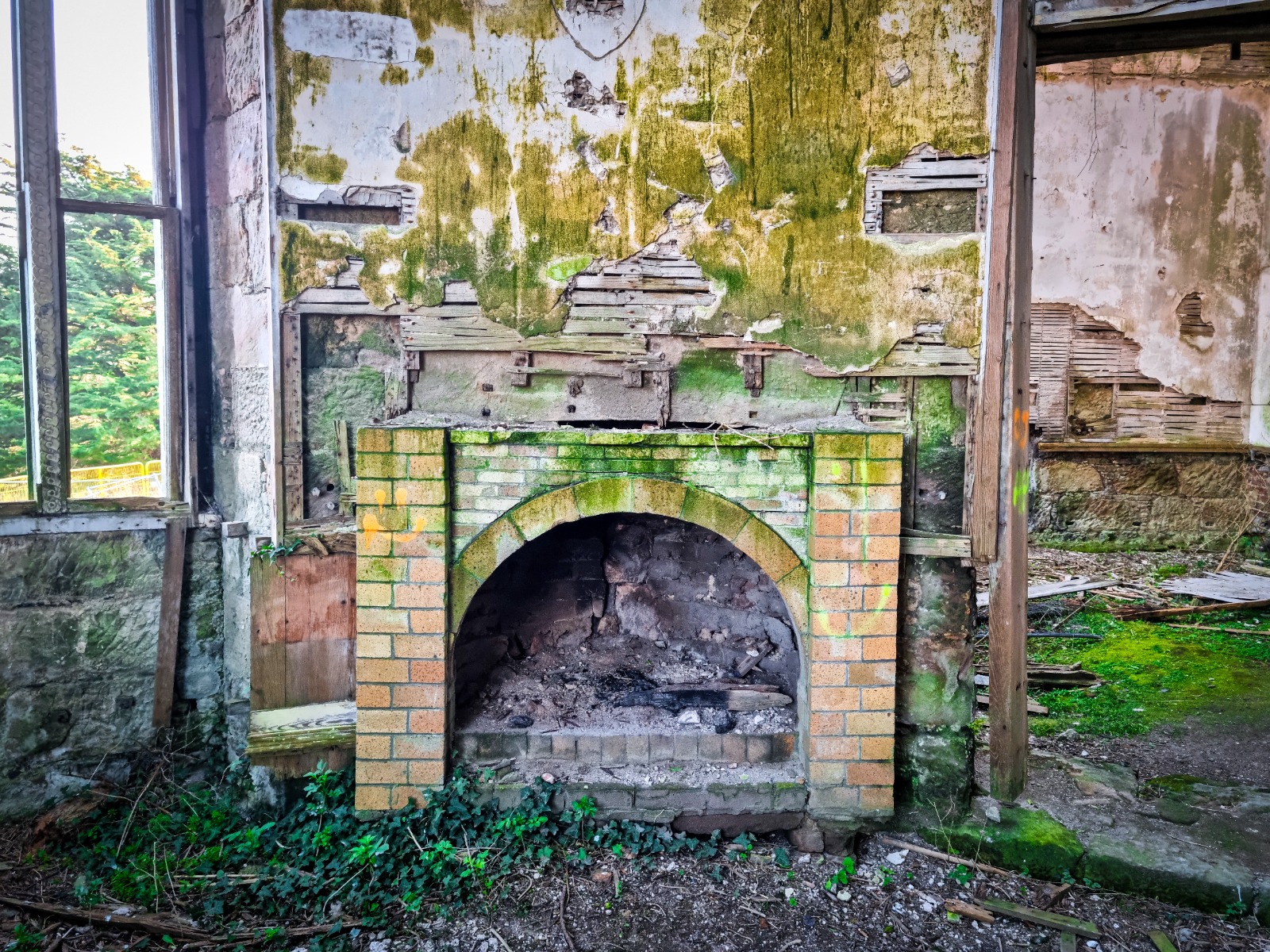 Antique fireplace inside the ruins of a house