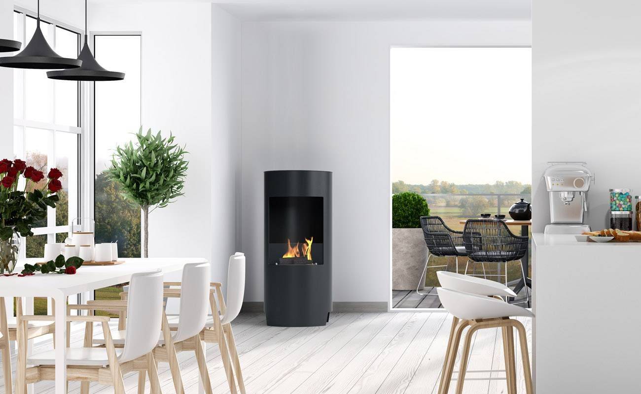 Black bioethanol fireplace in a white dining room with white table and chairs