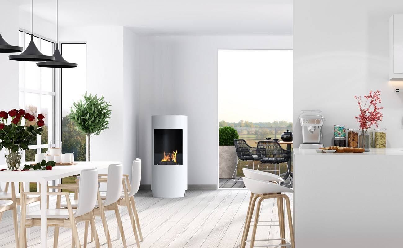 White bioethanol fireplace positioned in the corner of a white kitchen