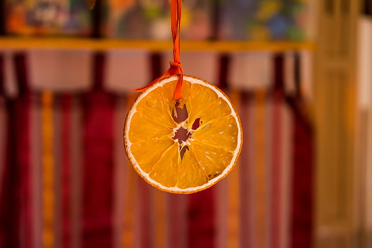 Orange slice hanging by a red string