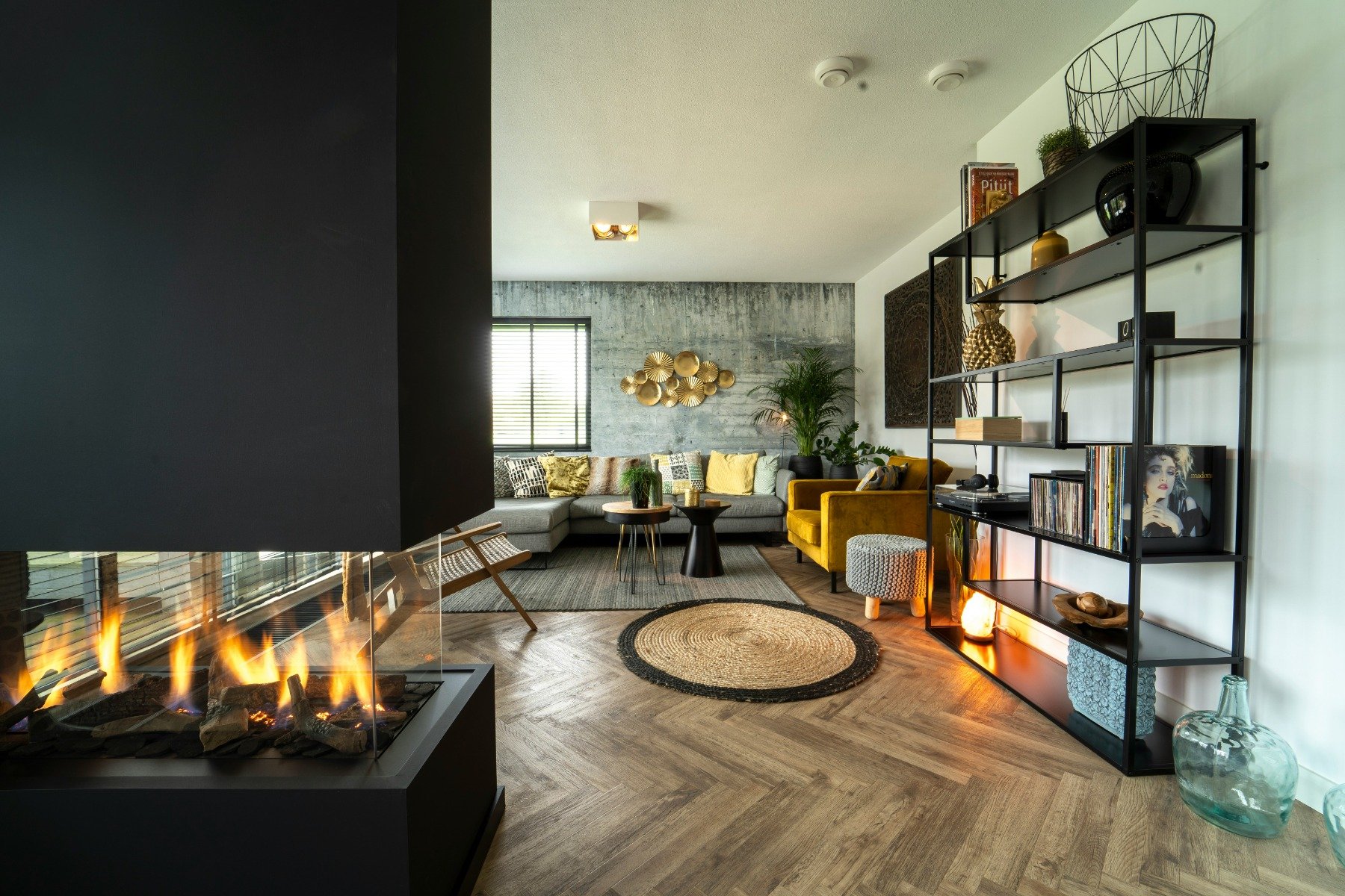 Black ventless fireplace in a contemporary living room with wicker rug