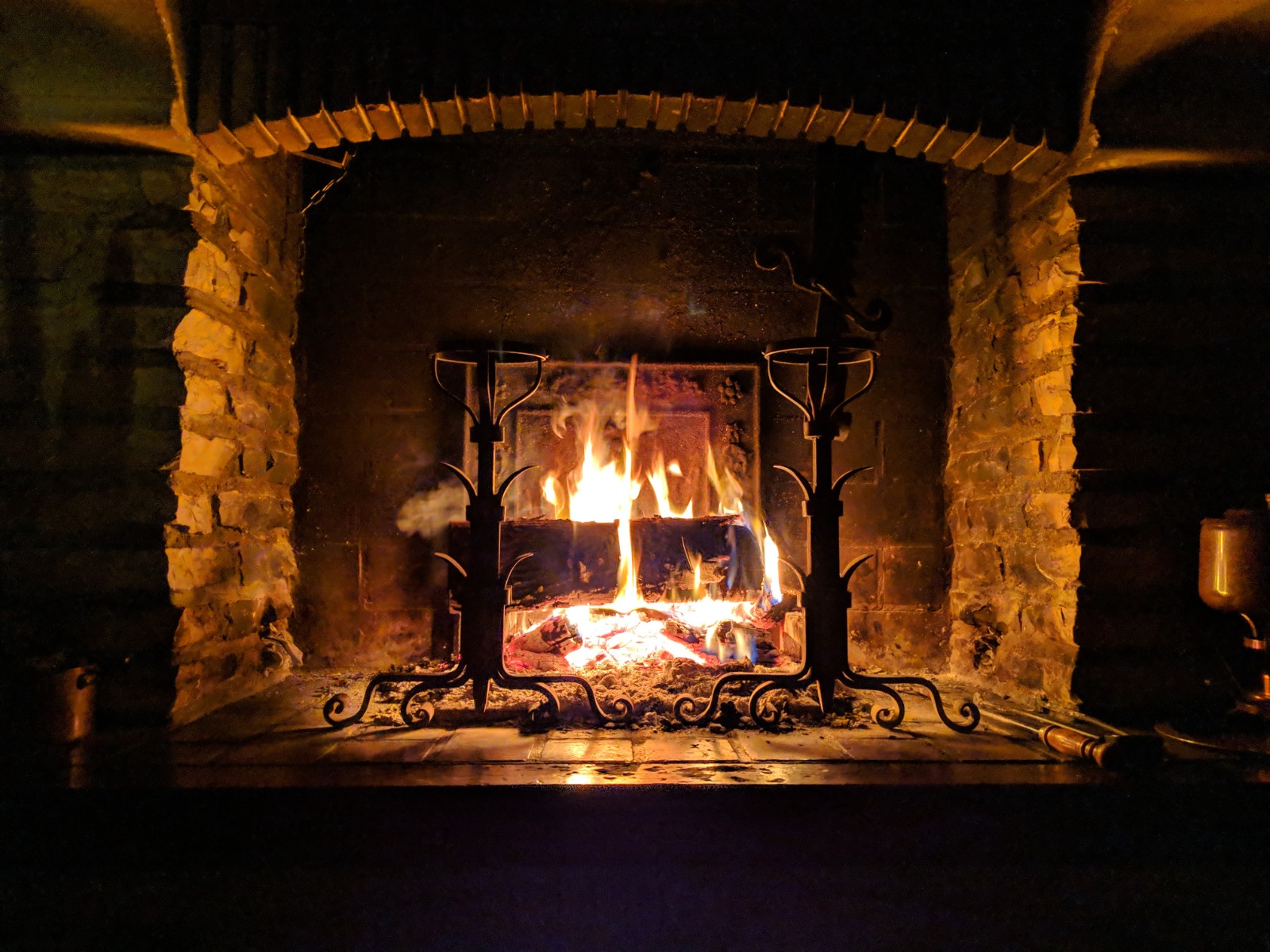 Open fireplace with fire burning