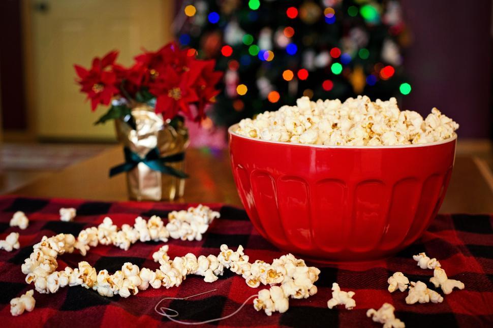 Popcorns on a string next to a bowl of popcorn